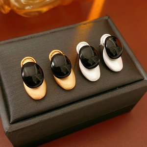 Detailed comparison of gold and silver base oval earrings with sleek black resin finish