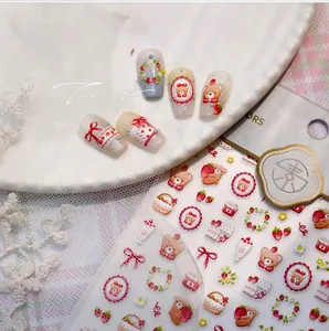 Macro shot of 5D cartoon strawberry bear embossed nail art stickers on display tips