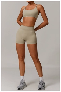 Close-up of seamless knitted yoga set with high-waisted shorts and thin strap sports bra
