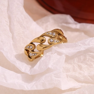 Detail of 18K gold plated stainless steel ring with teardrop pattern and white zircons
