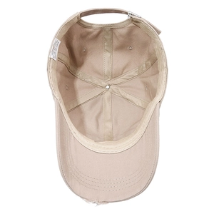 Inside view of khaki distressed cotton baseball cap showing stitching and fabric label