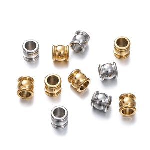 Detailed macro view of gold and silver stainless steel spacer beads for DIY jewelry