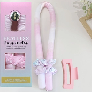 Flat lay of heatless hair curler set in pink gradient silk for long hair styling