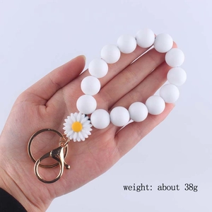 White silicone bead daisy wristlet keychain with gold buckle and flower charm