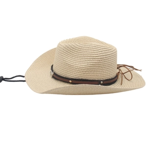 Detailed texture of hand-woven raffia straw cowboy hat with leather band and chin cord