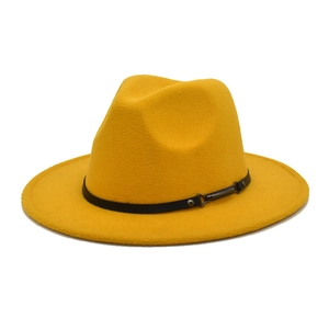 Detail of yellow wool fedora hat with a black leather belt and silver metal buckle