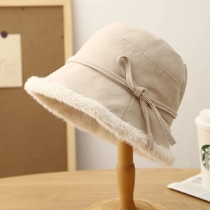Detailed view of winter bucket hat featuring plush faux fur trim and decorative bow knot