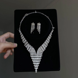 Elegant silver V-shaped fringe necklace and stud earrings set with sparkling rhinestones