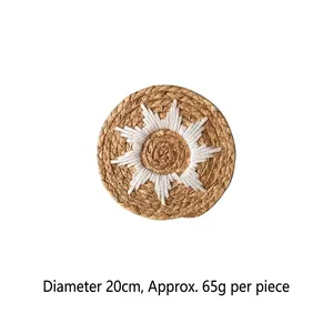 Handwoven straw wall decor in bohemian style with white sunburst embroidery, 20cm diameter
