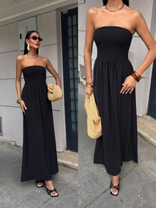 Detail of black strapless maxi dress with smocked bodice and breezy pleated fabric