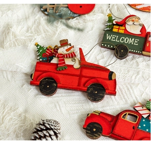 Close-up of a festive painted wooden Christmas truck ornament with snowmen and a Welcome sign