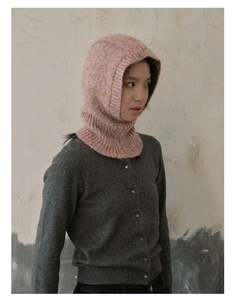 Detail of pink-orange knit balaclava showing ribbed texture and windproof neck design