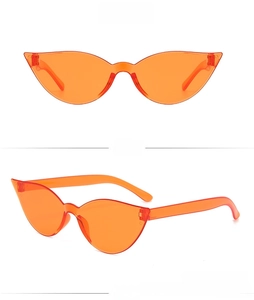 Detail view of orange cat-eye sunglasses with a rimless one-piece design and sharp angles