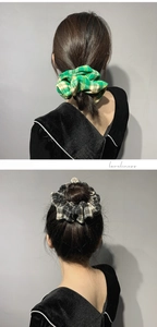 Detailed texture of green and black plaid scrunchies on ponytail and bun hairstyles