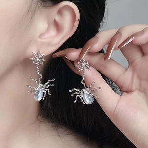 Silver spider earrings with moonstone accents and cobweb chain in punk metal style
