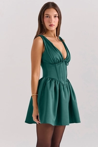 Detail of dark green satin mini dress with corset waist and deep V-neckline