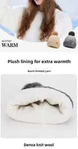 Detail of winter knit hat featuring soft white fleece lining and plush faux fur pom-pom