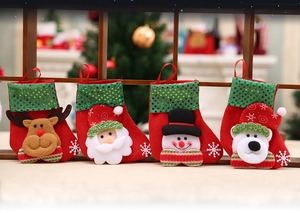Detailed view of four sequined Christmas stockings with 3D Santa and Reindeer figures