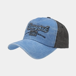 Detail of vintage washed baseball cap with Newyork 1985 embroidery and distressed denim fabric