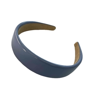 Minimalist blue PU leather headband with brown inner lining on white background