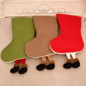 Detailed view of red green and brown Christmas stockings with dangling elf legs and boots