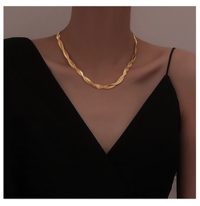 Detail of twisted double strand gold snake chain necklace on female model neck