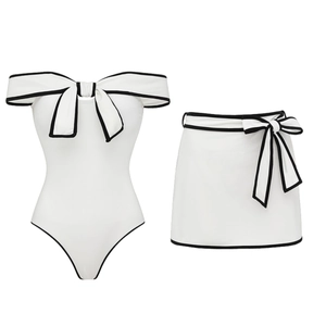 Elegant white one-piece swimsuit with black bow trim and matching skirt, Hepburn style