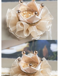 Detail of baby princess crown hair clip with gold beads and beige satin fabric