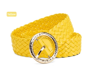 Close-up of bright yellow woven PU leather belt with a round gold metal buckle