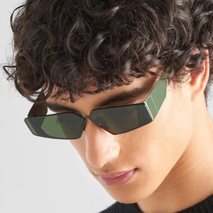 Futuristic Y2K rimless sunglasses with dark green geometric lenses on male model face