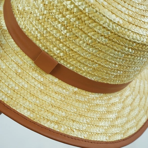 Classic khaki straw boater hat with brown leather belt detail for sun protection