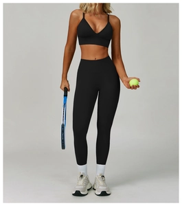 Detail of a black seamless yoga set with double straps and high-waisted leggings