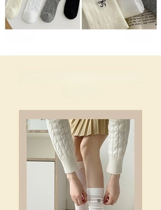 Detailed view of women's knit socks featuring delicate black bow embroidery and ribbed texture