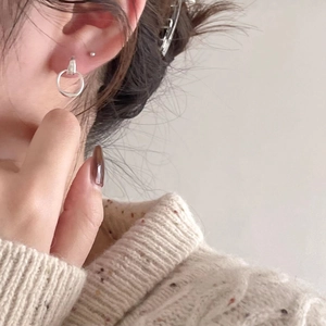 Minimalist S925 sterling silver small stud and hoop earring set shown on model's ear
