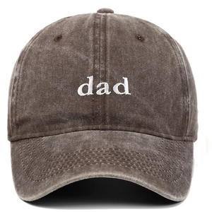 Detailed close-up of white 'dad' embroidery on washed cotton vintage baseball cap
