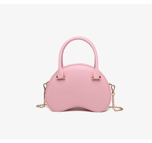 Pink jelly bag detail showing smooth matte PVC material and gold metal chain strap