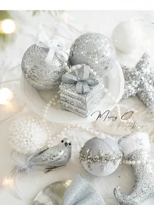 Detail of silver Christmas tree ornaments including glitter stars and beaded foam balls