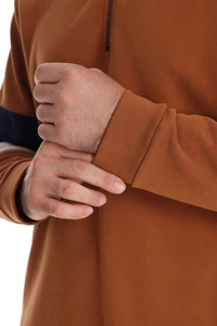 Detail of ribbed cuffs and caramel brown knitted fabric on men's long sleeve polo sweatshirt