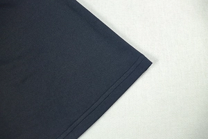 Detail of professional double-line stitching on the hem of a navy knit bodycon dress