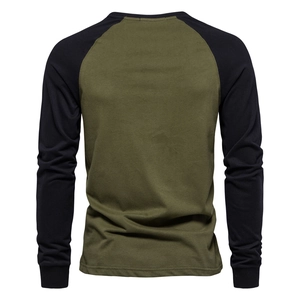 Detail view of the back of a raglan long sleeve T-shirt with green and black stitching