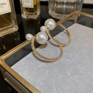 Elegant geometric hoop earrings with sparkling cubic zirconia and two white pearls