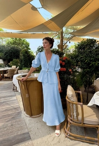 Close-up of light blue linen V-neck puff sleeve top and A-line long skirt set detail