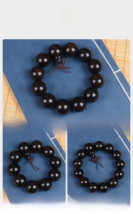 Detailed view of polished Ebony Wood prayer beads in three sizes on a bamboo mat