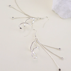 Elegant silver tassel earrings with spiral design and sparkling crystal charms