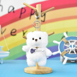 Detailed view of cute white plush bear keychain featuring a miniature purple guitar charm