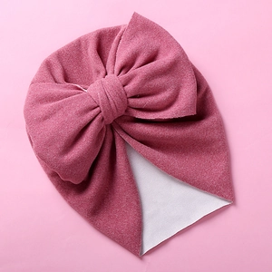Soft pink baby turban hat with double-layered bow and cashmere-like texture for winter