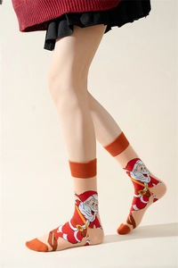 Detail of cotton Christmas socks with Santa Claus print on orange and beige knit