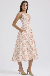 Close-up detail of the pink floral print and practical side pocket on a slim summer dress
