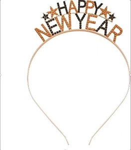 Macro detail of HAPPY NEW YEAR rhinestone headband with golden star decorations