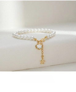 Detailed close-up of S925 silver pearl bracelet with starfish and seashell charms